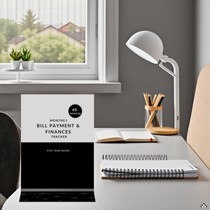 A desk with a laptop, calculator, and a pen surrounded by various financial documents and a potted p
