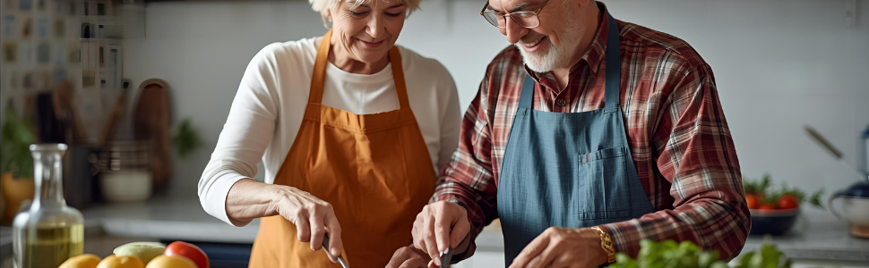 Smiling senior couple cooking together in the kitchen.