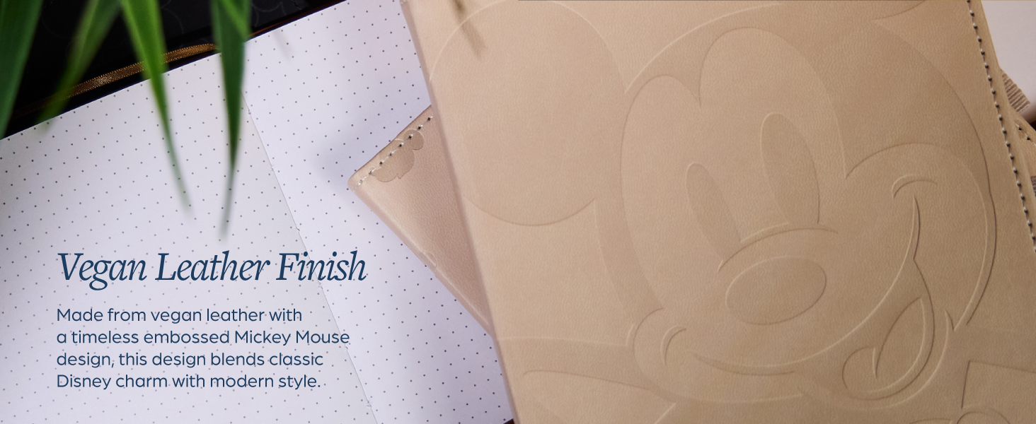 The cover of a Mickey Mouse book journal. Text reads: Vegan leather finish.