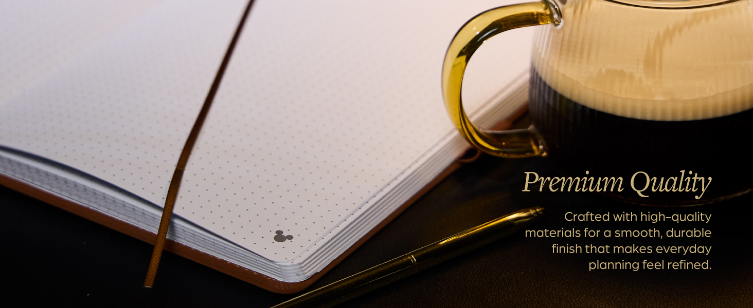 A Disney dotted journal next to a mug. Text reads: Premium quality.