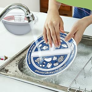 The plates and bowls being washed in the sink.