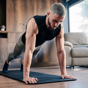 Man doing exercises on a mat at home