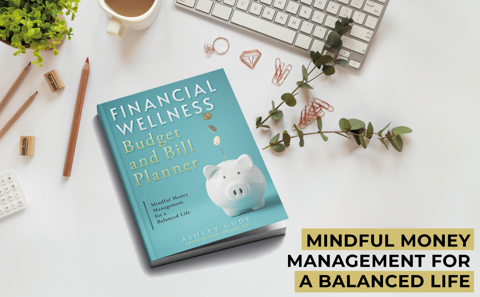 Aqua planner cover with piggy bank with coins flowing into the bank set on top of a white desktop